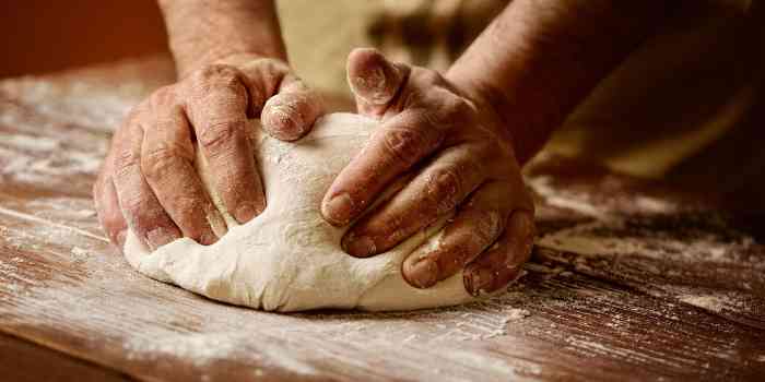 Man kneading bread dough