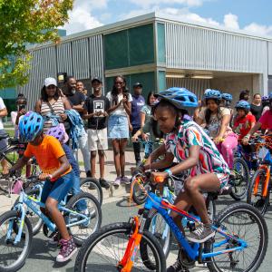 Children racing on their new bikes at the Tour de DUKE Heights race