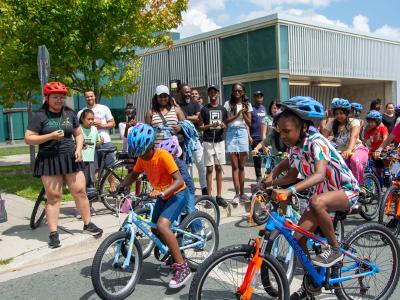 Children racing on their new bikes at the Tour de DUKE Heights race