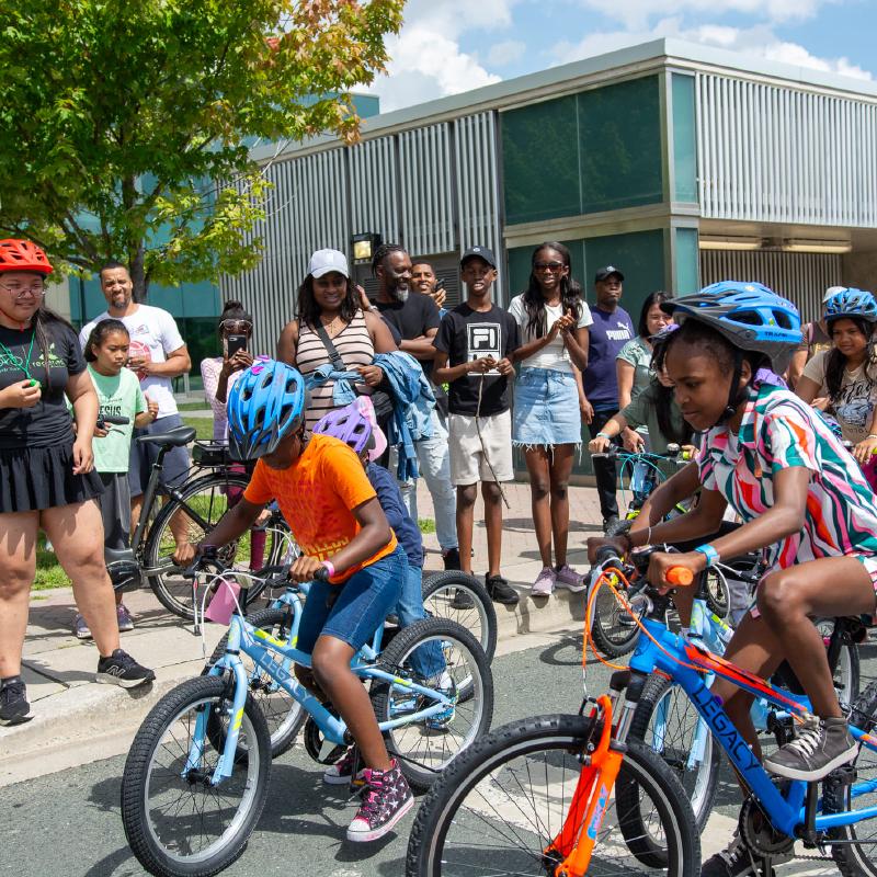 Children racing on their new bikes at the Tour de DUKE Heights race